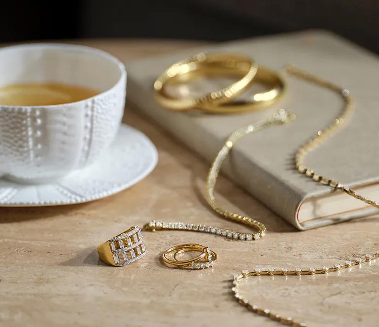 An assortment of yellow gold lab grown diamond jewelry